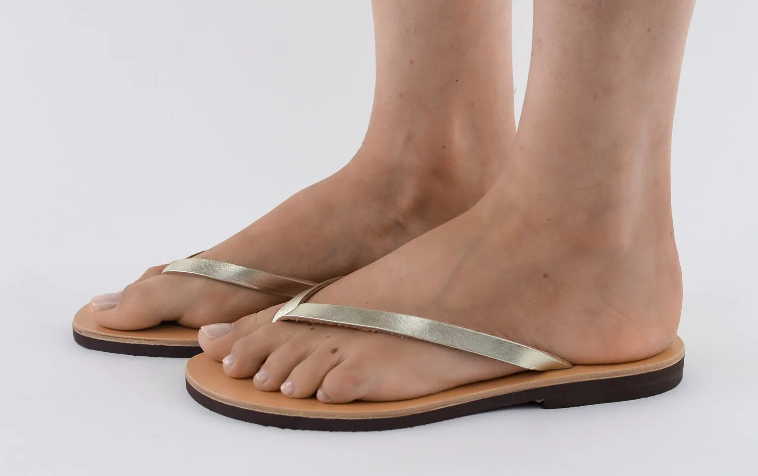 APHRODITE GOLD LEATHER FLIP-FLOPS