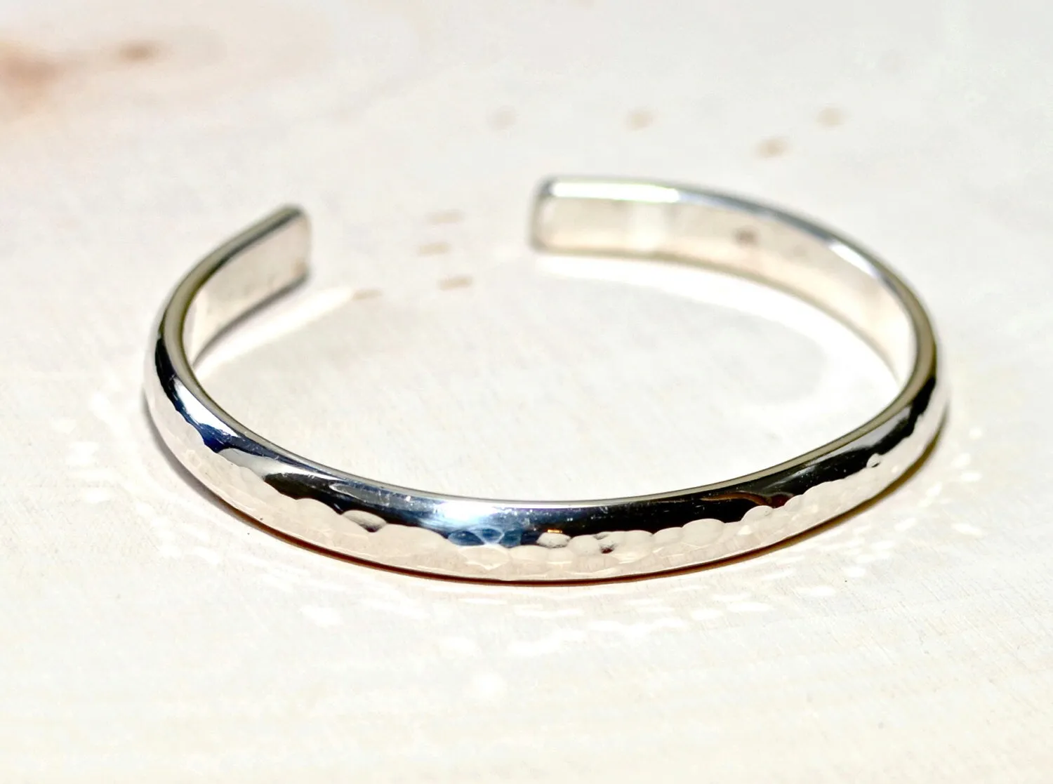 Sterling silver half round bracelet with hammered texture and mirror finish