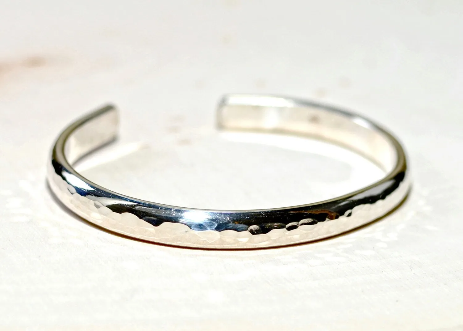 Sterling silver half round bracelet with hammered texture and mirror finish