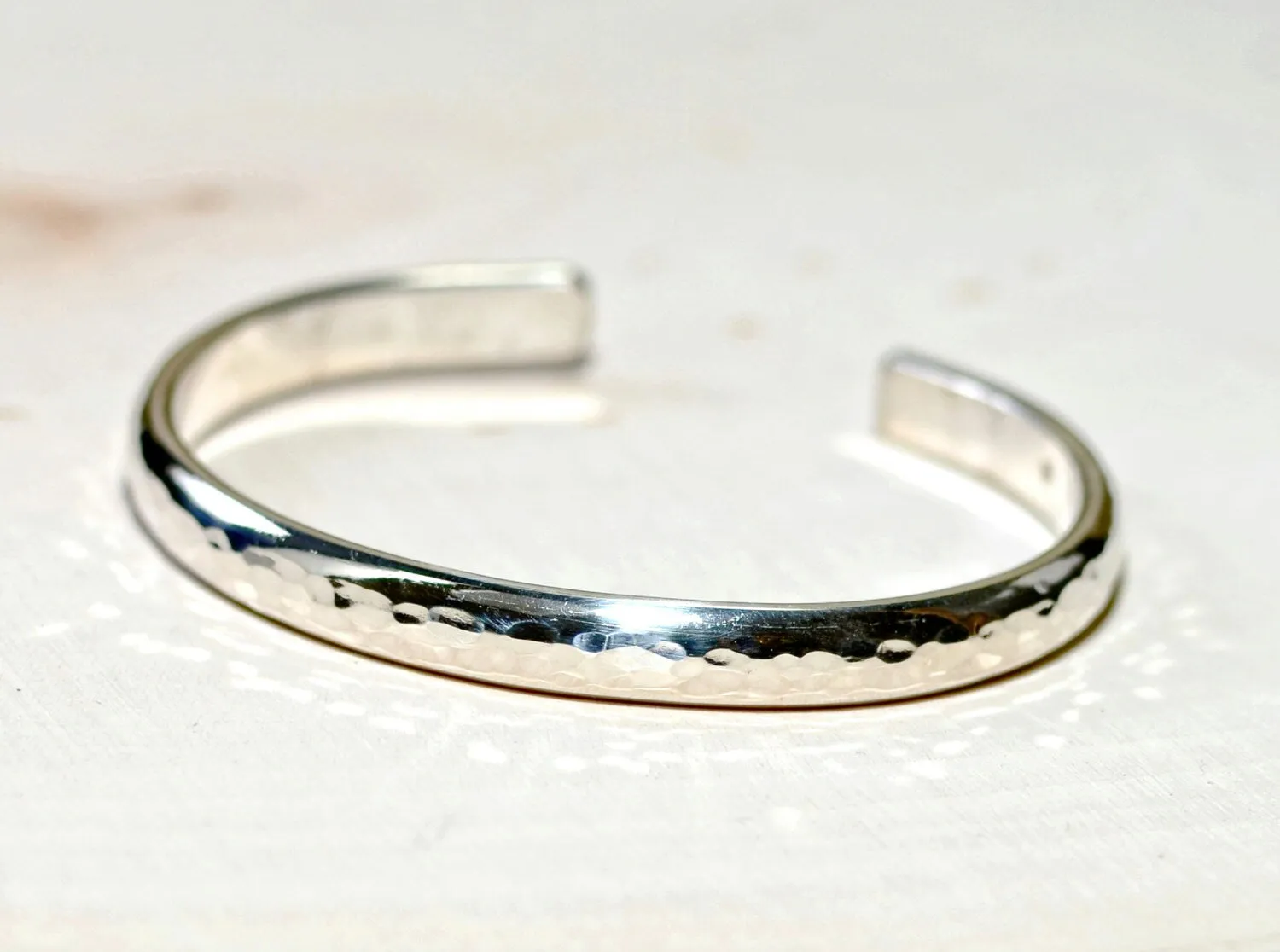 Sterling silver half round bracelet with hammered texture and mirror finish