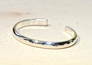 Sterling silver half round bracelet with hammered texture and mirror finish