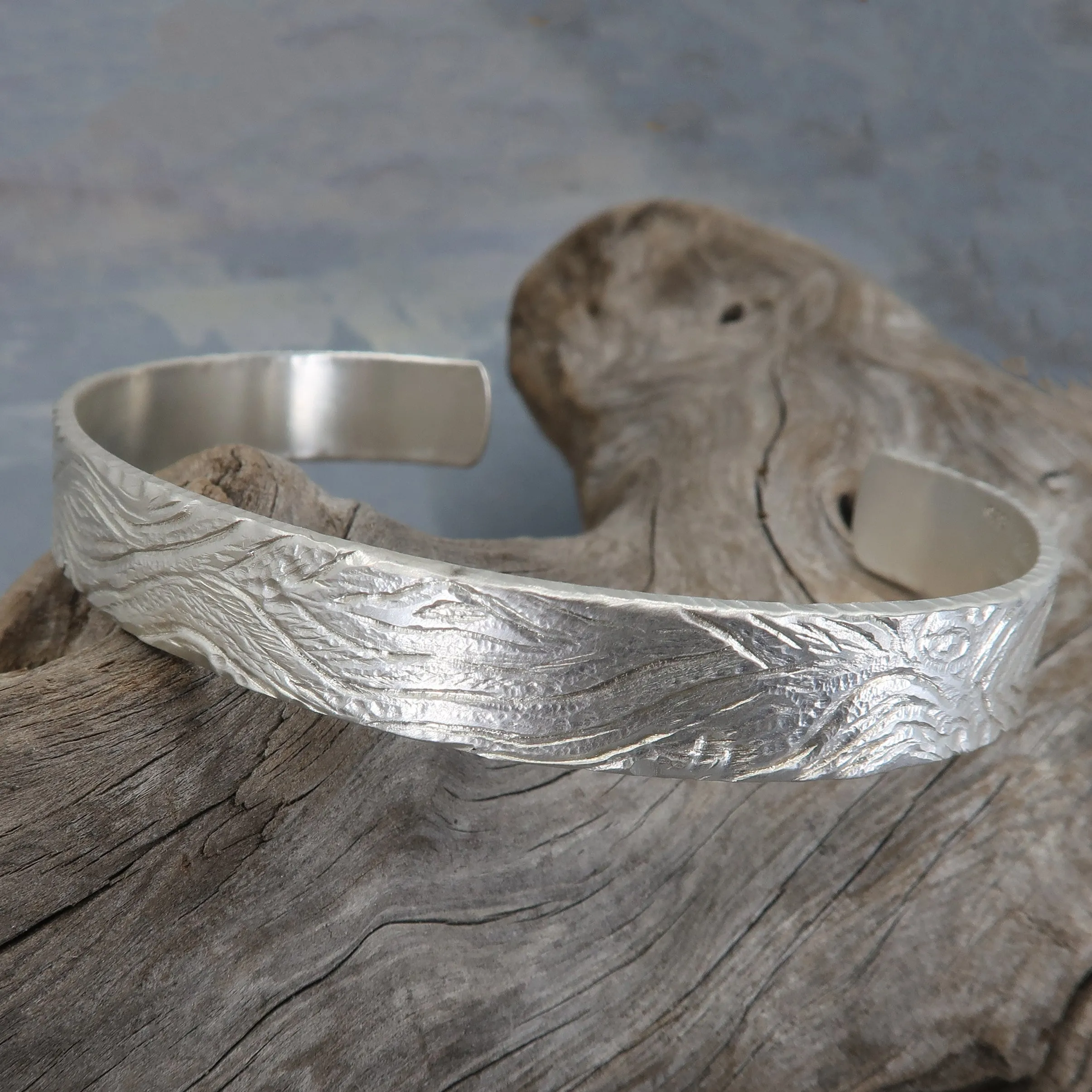 Unique carved sterling silver cuff bracelet with a wood pattern