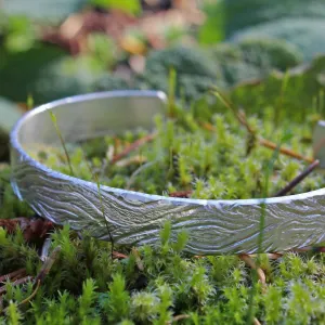 Unique carved sterling silver cuff bracelet with a wood pattern